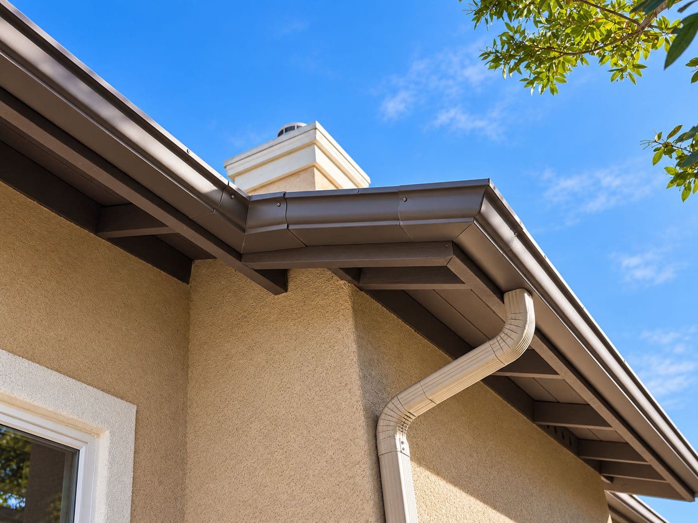 Clean gutters and downspout on a stucco home