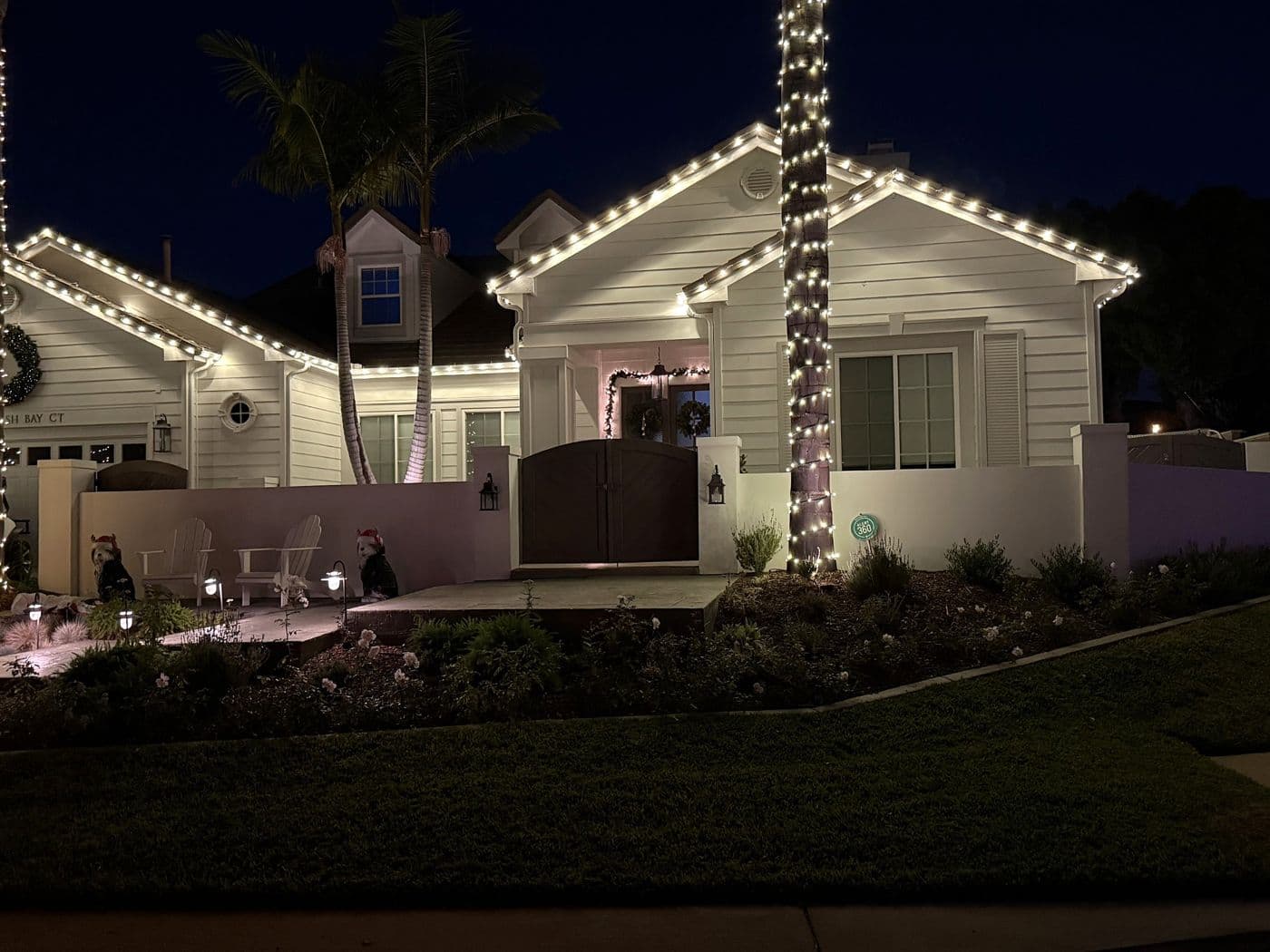 White holiday lights along the roofline of a single-story home