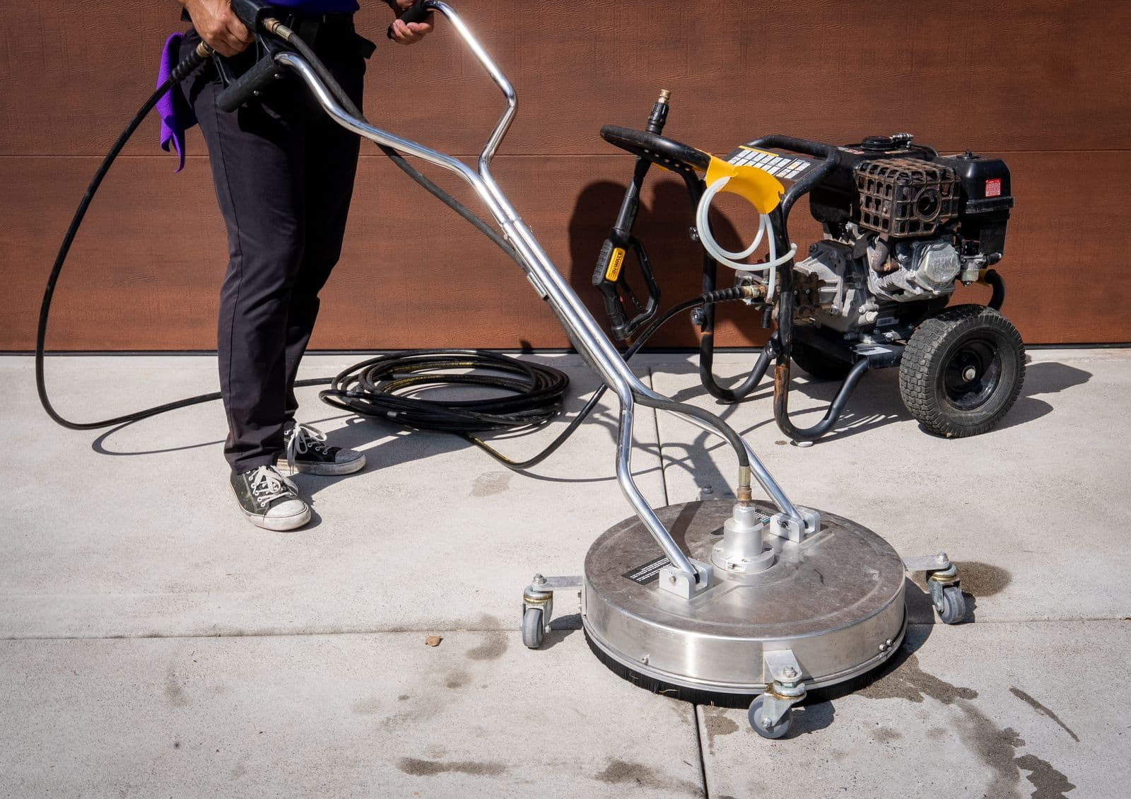 RadPad rotary surface cleaner and pressure washer staged on a driveway