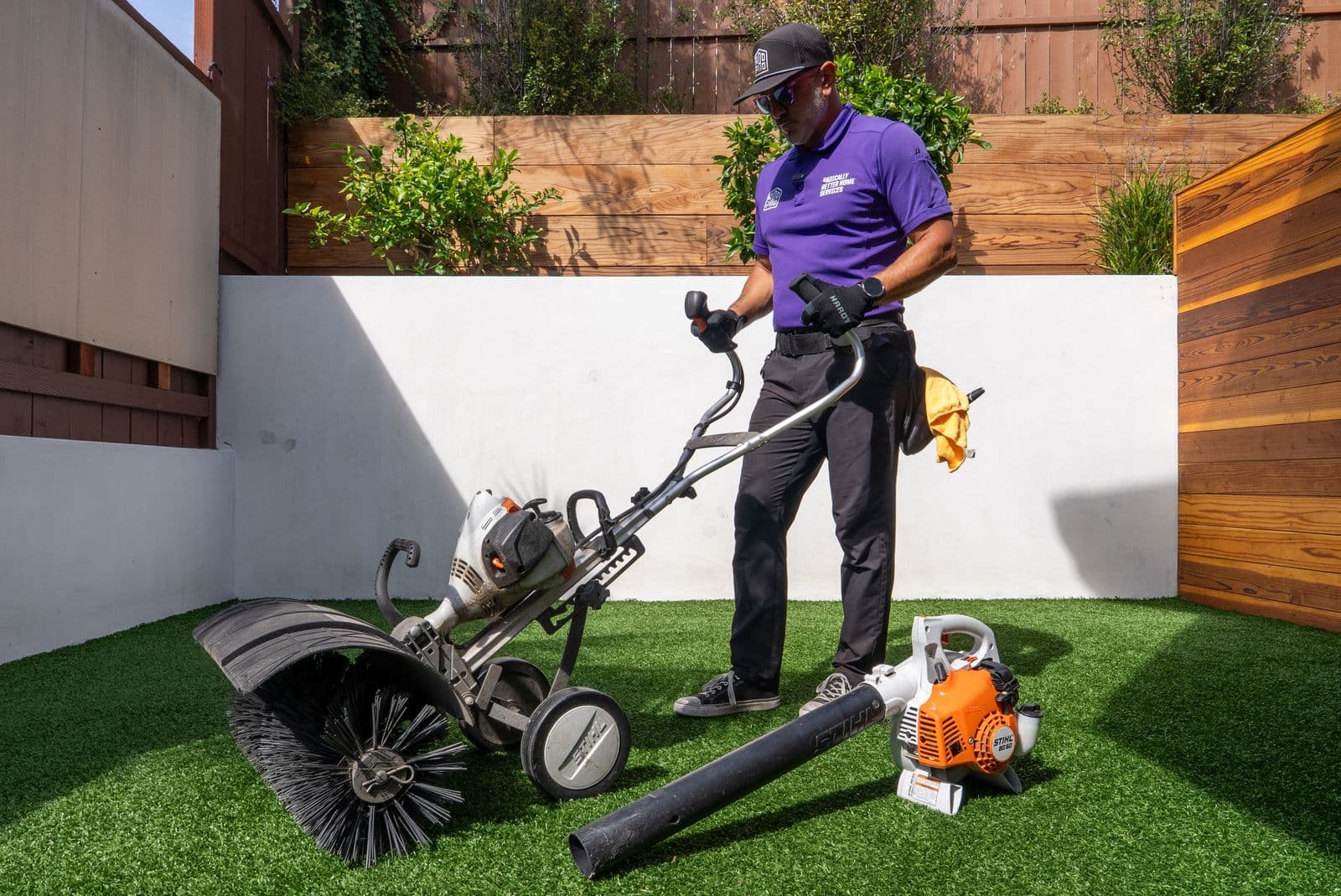 Technician grooming artificial turf