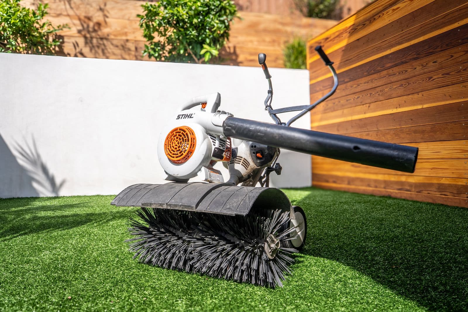 Power-brooming an artificial turf lawn