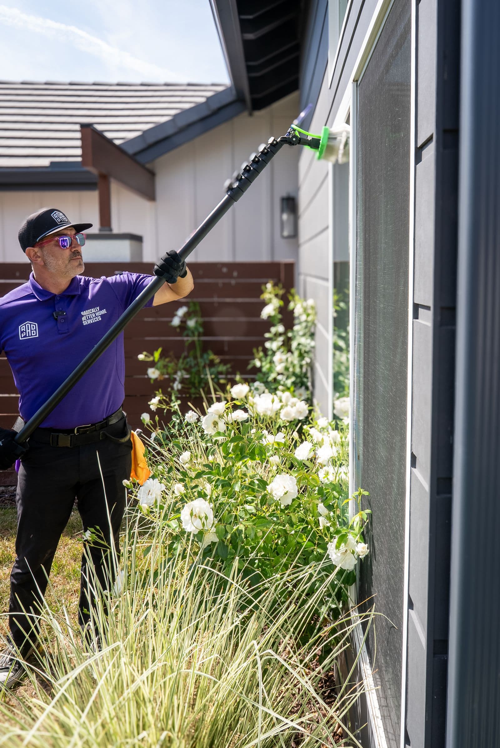 RadPad technician cleaning exterior glass with an extension pole