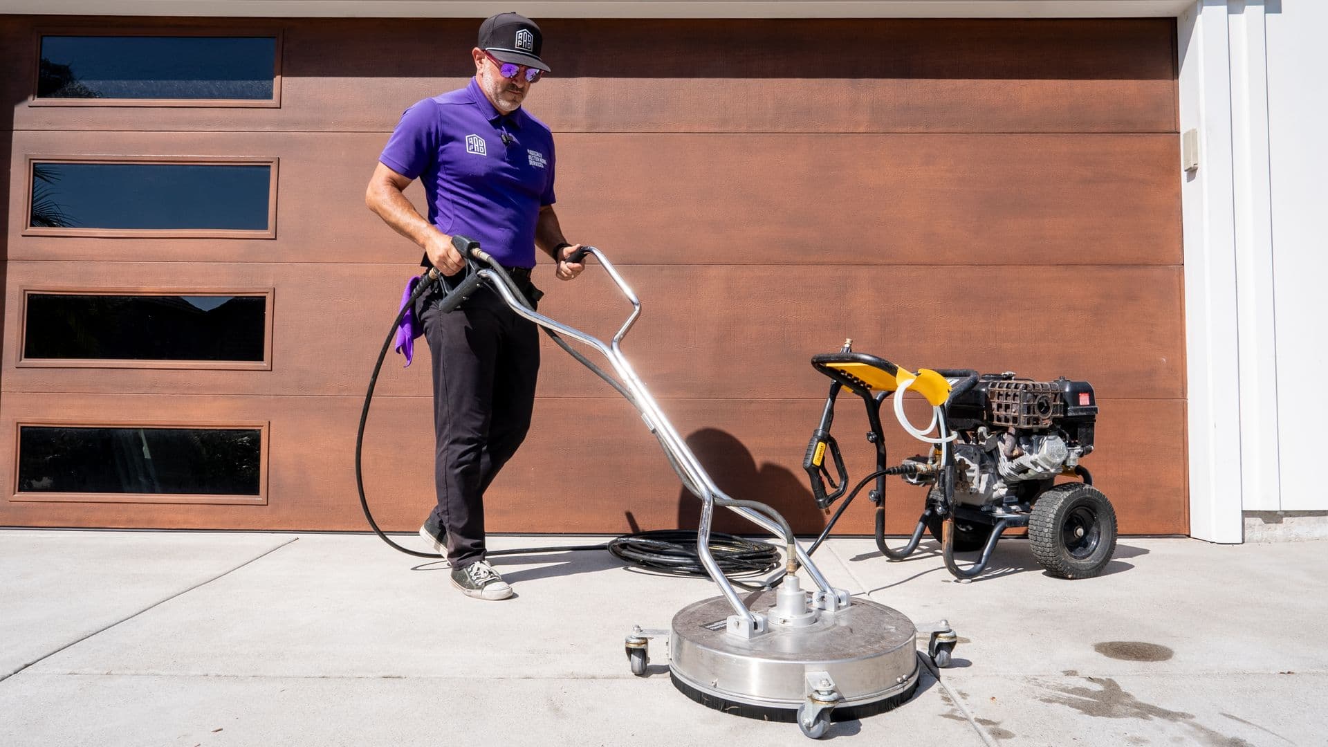 RadPad rotary surface cleaner restoring a concrete driveway