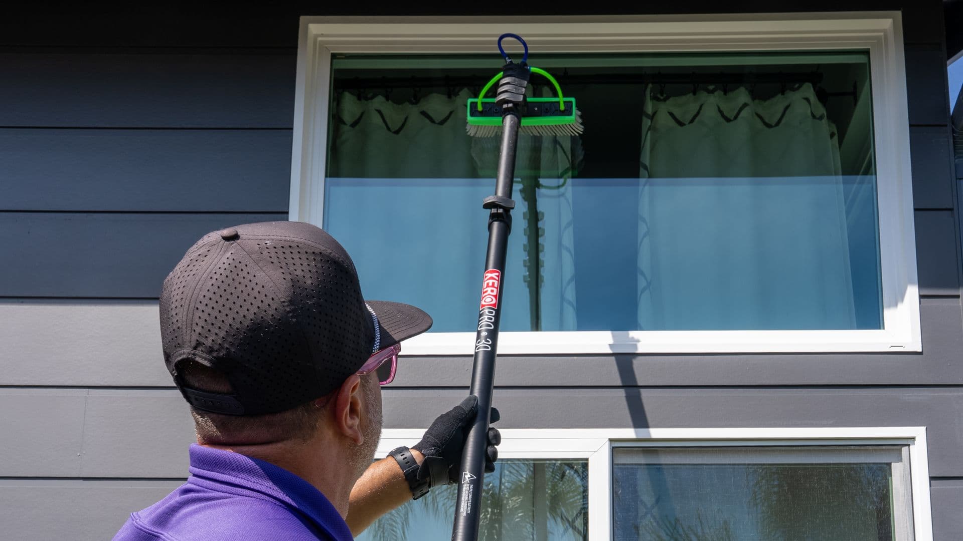 RadPad technician cleaning exterior glass on a San Diego home